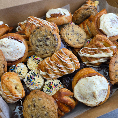 A catering tray of 25 bite-sized desserts — mini cupcakes, Danishes, petits fours and macarons — Radical Gardens bakery in Timmins