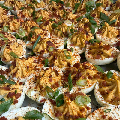Catering tray of twenty-four deviled eggs piped to order with a scratch-made base and finished by the chef — Radical Gardens, Timmins