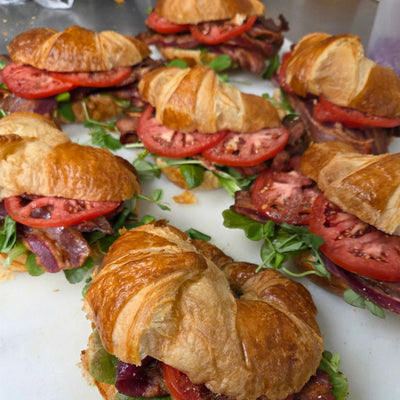 Six B.L.T croissant sandwiches on butter croissants with local bacon, fresh tomato, lettuce and mayonnaise, boxed for catering — Radical Gardens, Timmins