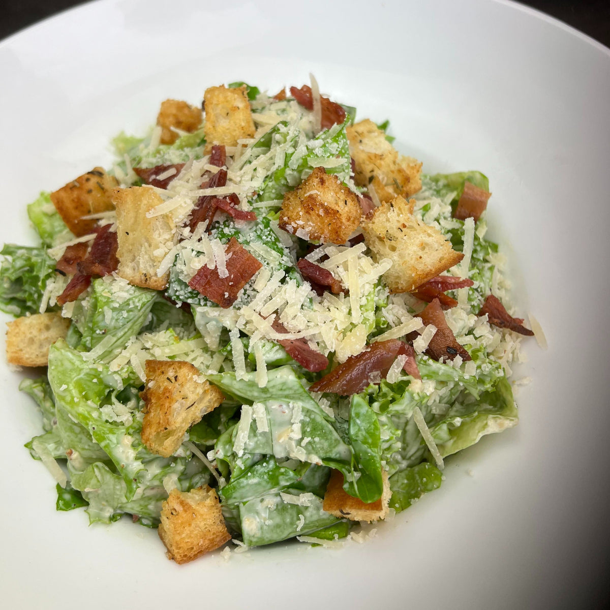 Catered Caesar salad bowl for 6 with crisp local romaine, scratch-made dressing on the side, house-made croutons, local bacon and grated Parmesan — Radical Gardens, Timmins