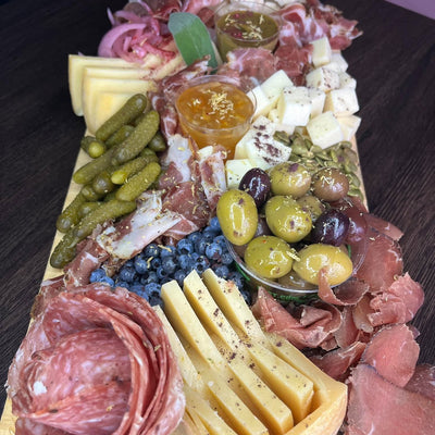 Charcuterie board of house-cured meats, artisan cheeses from Canada, Italy and Spain, pickles and house-made dips, displayed on a wood board — Radical Gardens, Timmins
