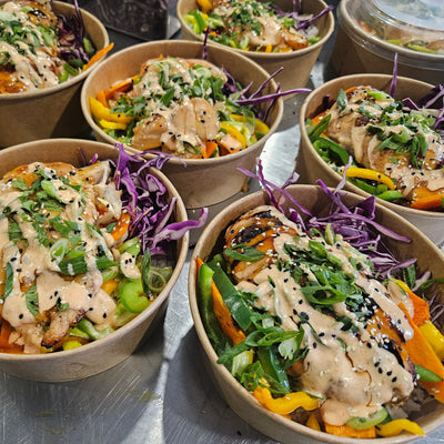 A warm chef-built catering entree for ten — protein with rice, roasted vegetables and sauce — from Radical Gardens in Timmins