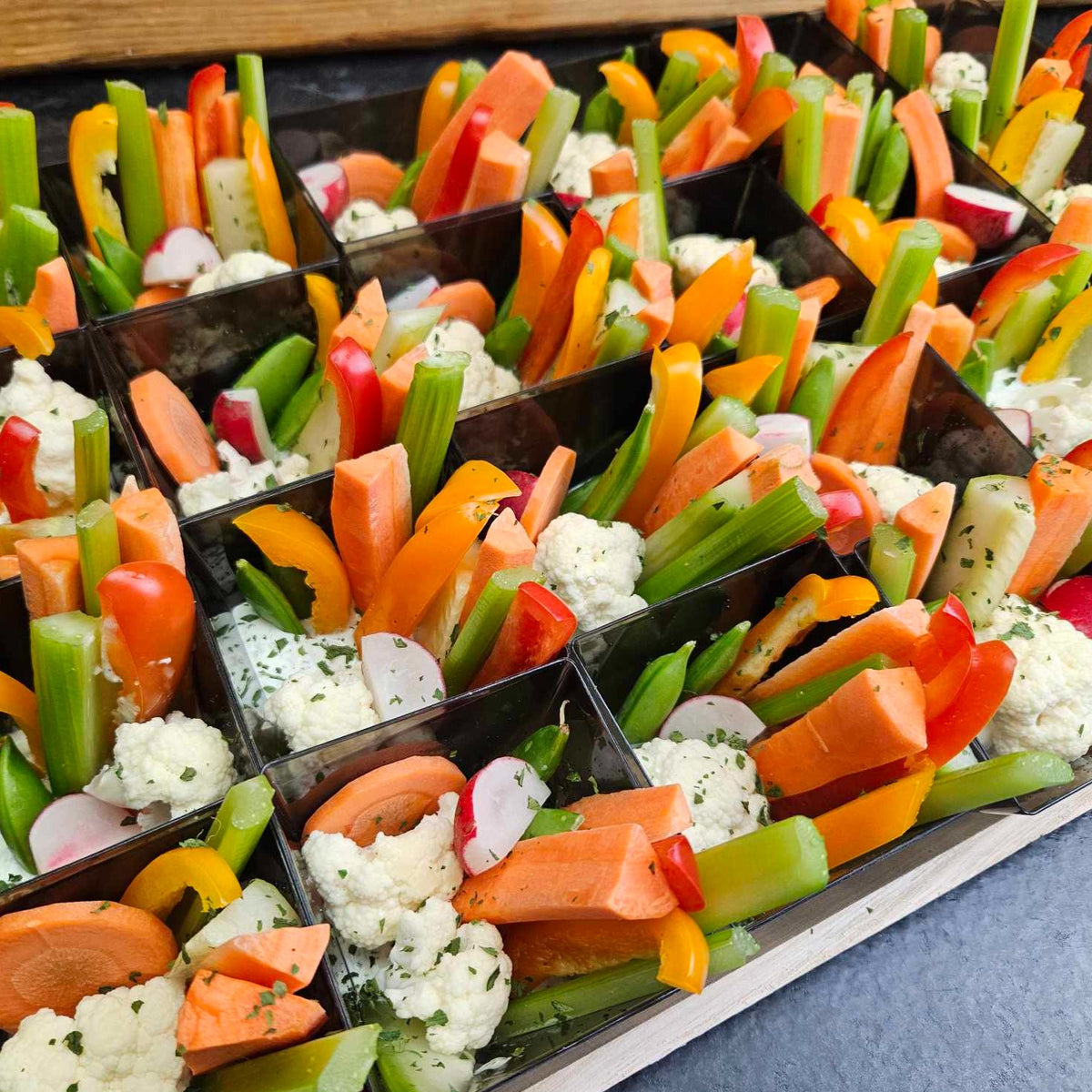 Individual catering cups of seasonal vegetables standing in house-made ranch dip, ready to hand out — Radical Gardens, Timmins