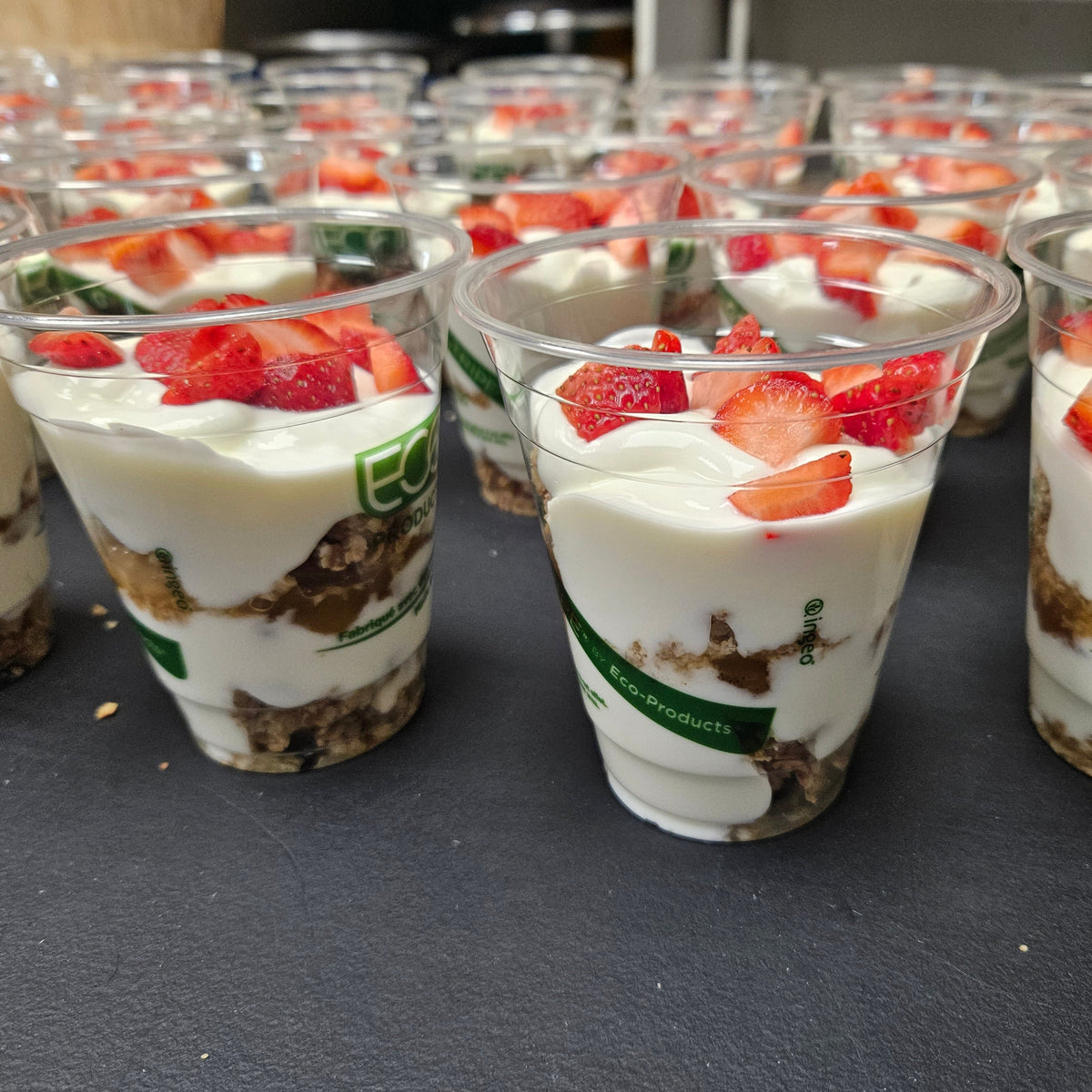 Individually portioned catering yogurt parfaits layered with house-made granola and seasonal berries in serving cups — Radical Gardens, Timmins