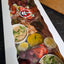 A ploughman's grazing box from Radical Gardens — thick-cut ciabatta, artisan cheese wedges, cold cuts, pickles and chutneys laid out for building sandwiches, Timmins